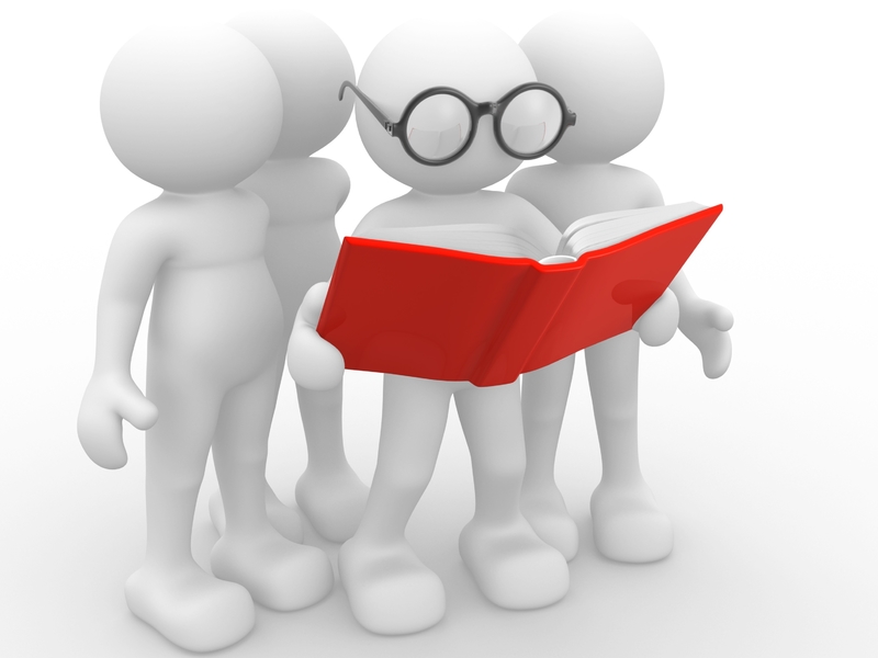Plusieurs bonhomme regardant par dessus l'épaule d'un dernier qui lit un document dans un grand livre rouge.
