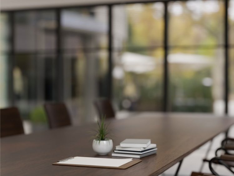 Image en gros plan d’une table de réunion en bois dur dans une salle de réunion moderne et spacieuse. Espace de travail professionnel.